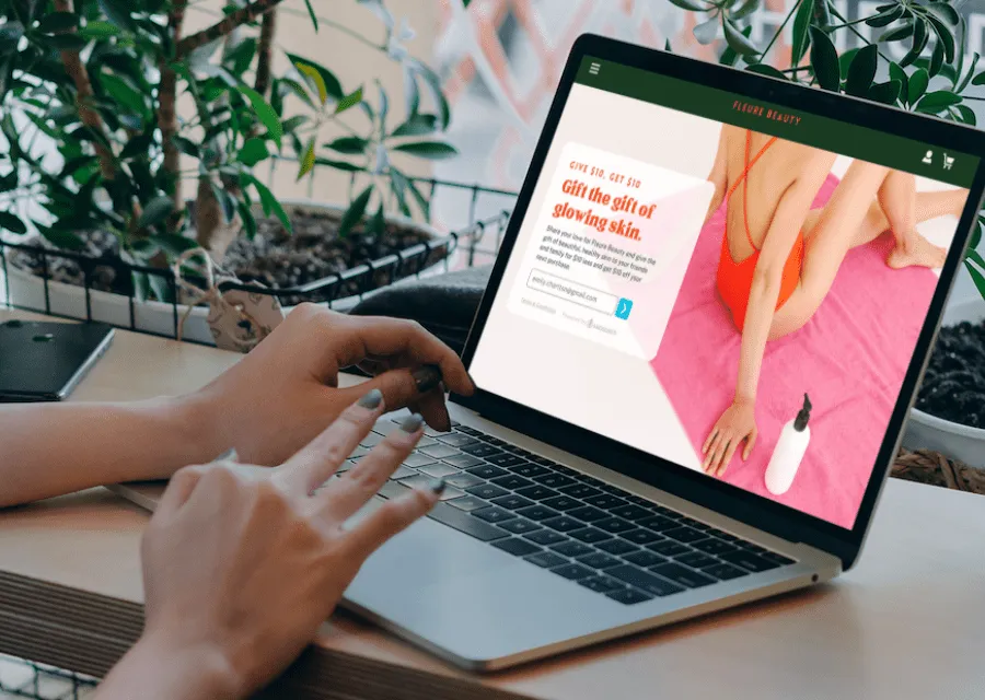 woman sitting at a desk participating in a ecommerce referral program